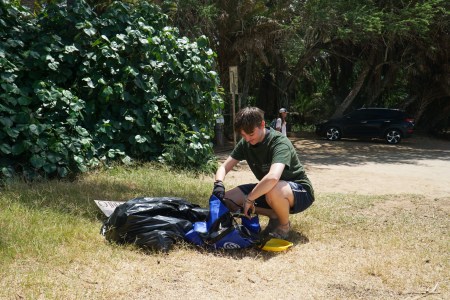 a young boy sitting at a park